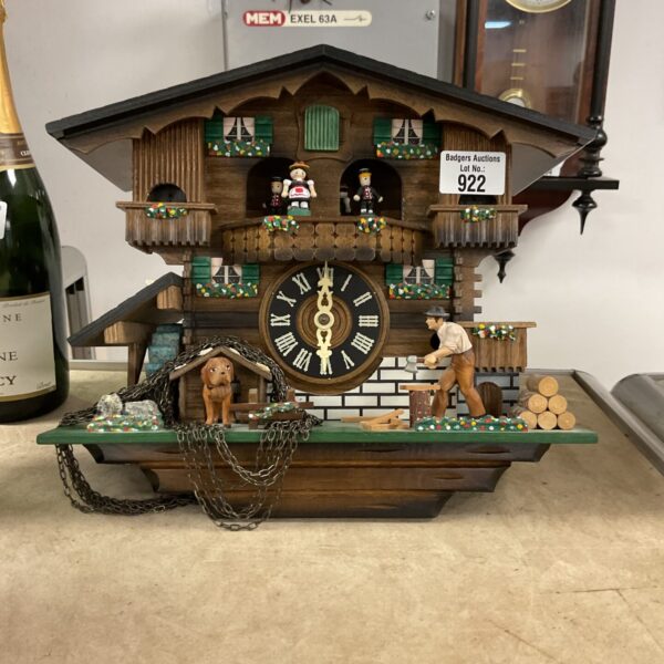 Detailed vintage German cuckoo clock, model EXEL 63A, with animated figures.