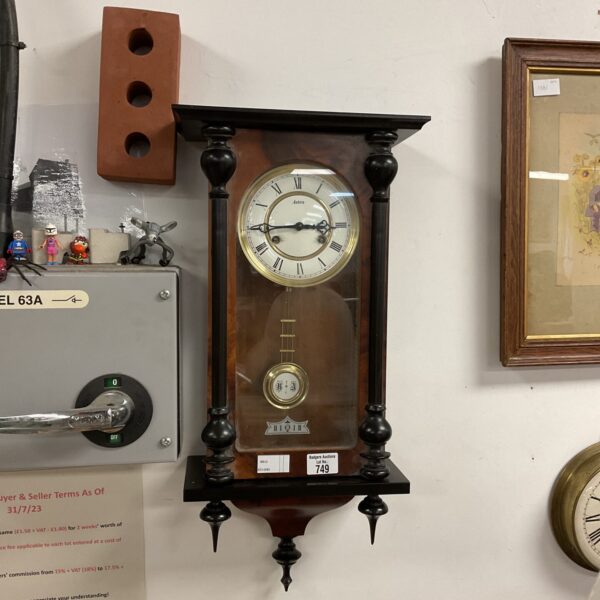 Vintage Astra wall clock in walnut case, retro timepiece.