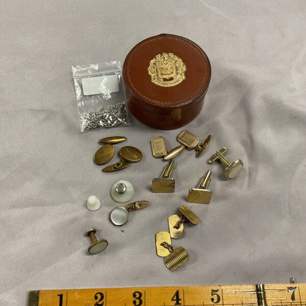 Assorted vintage cufflinks in a leather pot, men's jewellery.