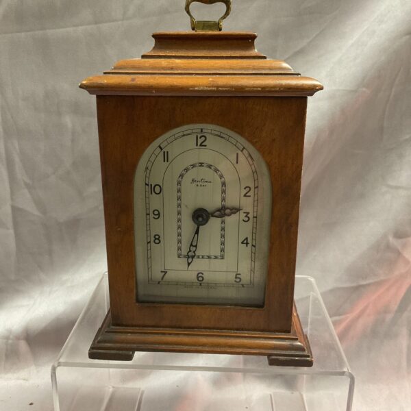 Vintage Bentima mantle clock with wooden case and clear dial.
