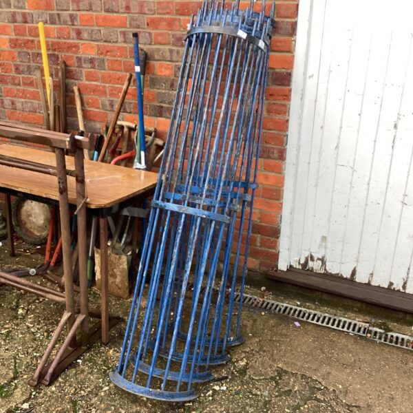 Set of metal tree protectors for young trees in a garden.