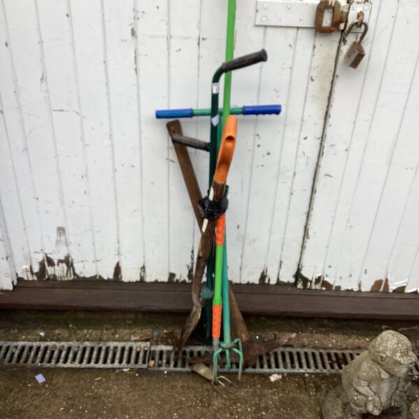 Vintage garden tool set with spade, fork, and pickaxe.