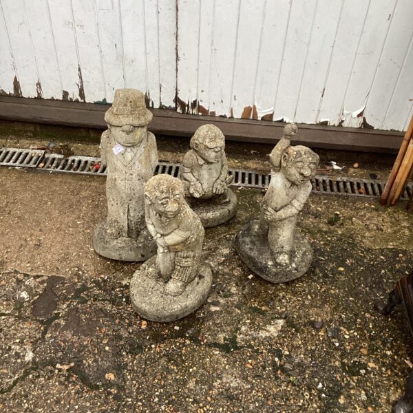 Vintage garden cricket ornaments set in a garden setting.