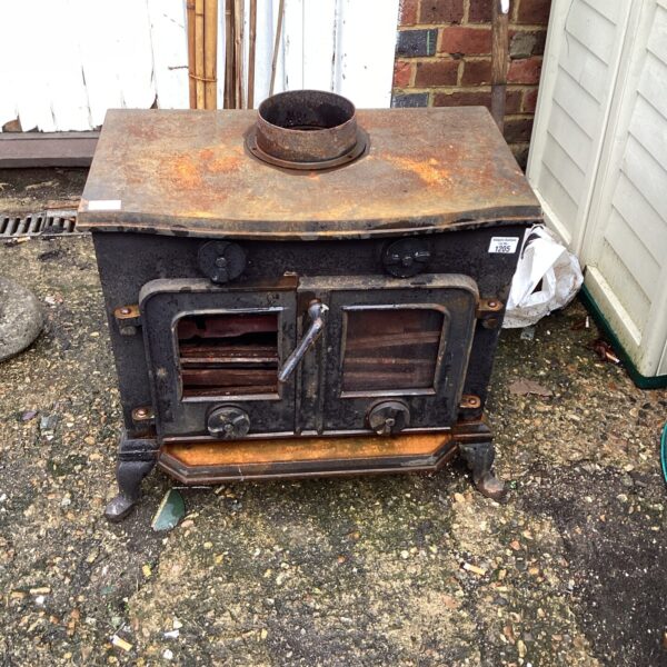 Antique cast iron log burning fire, front view.
