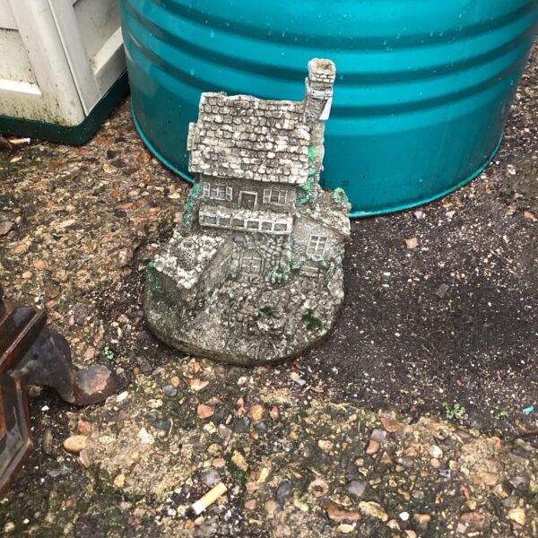 Detailed garden house ornament for whimsical garden decor.