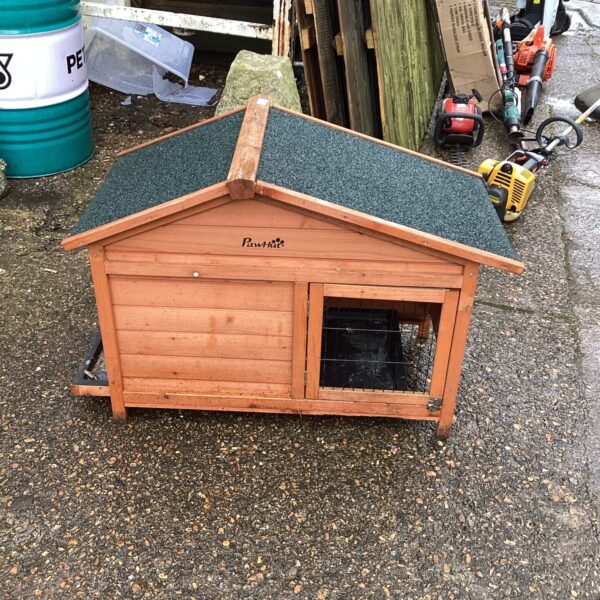 Wooden Pawhut animal hutch in a garden setting.