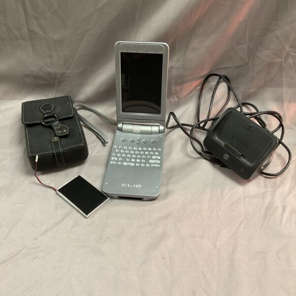 Silver Sony Clie NX73V PDA with docking station and accessories.