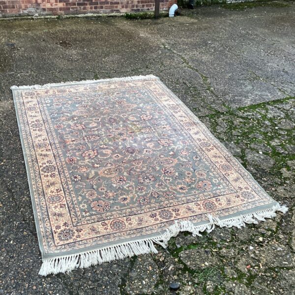 Large Moroccan rug with detailed floral pattern on a grey background.