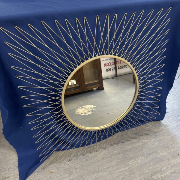 Large sunburst mirror with a vintage wire frame.