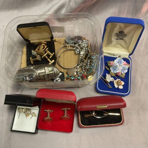 Vintage mixed jewellery and cufflinks lot on display.