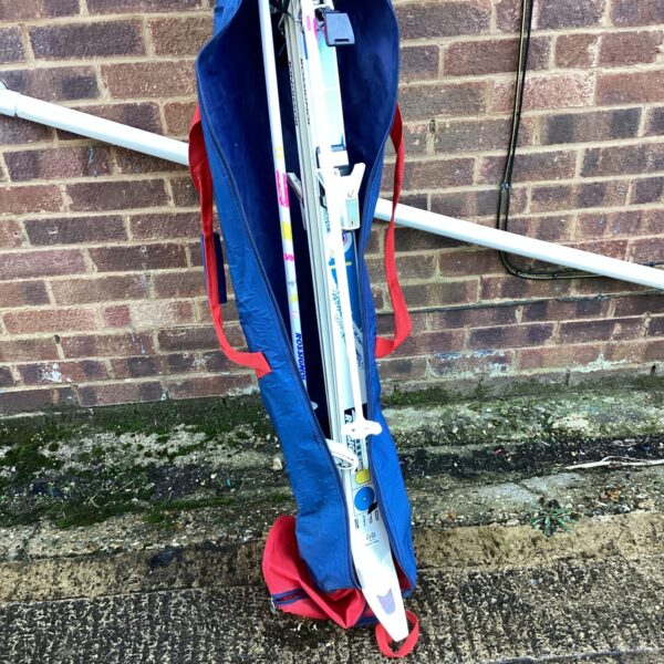 Rossignol ski set with poles and blue ski bag.