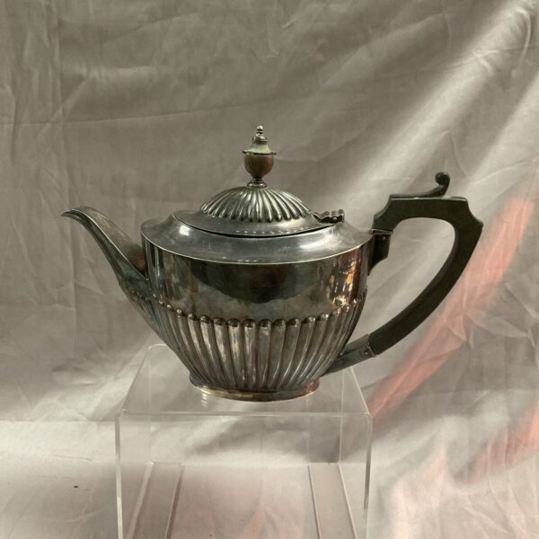 Antique Harrods pewter teapot with fluted detailing.