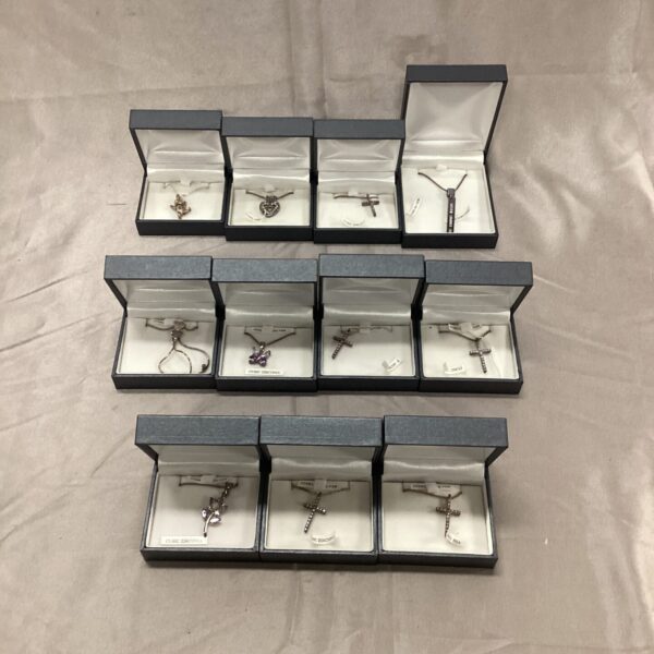 Lot of eleven sterling silver pendant necklaces with varied designs.