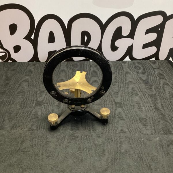 Vintage brass military compass mount for navigation instruments.