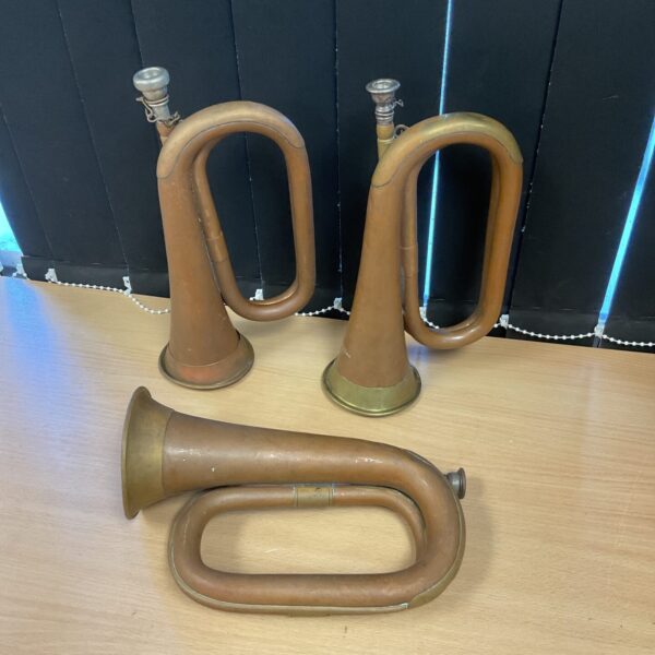 Lot of three vintage copper bugle horns from Boosey & Hawkes.