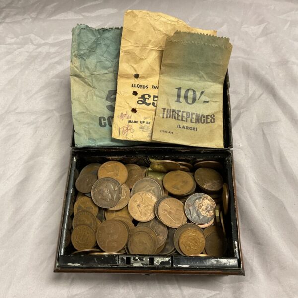 Vintage copper coin collection in a small tin.