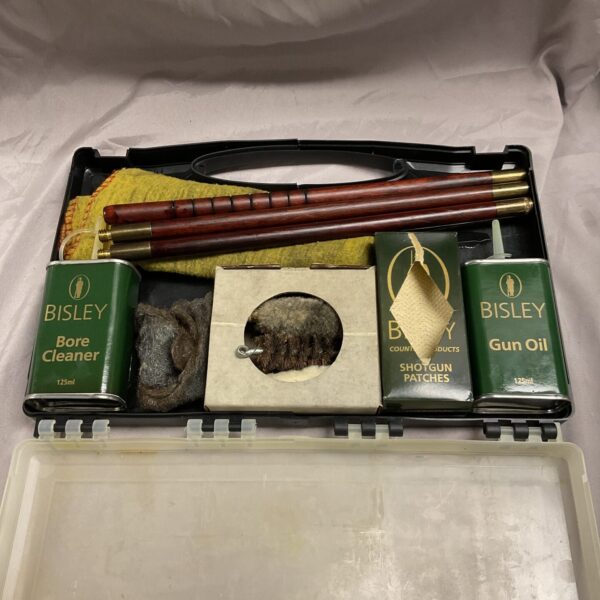 Open Bisley shotgun cleaning kit with tools and oil.