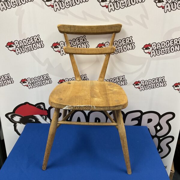 Vintage Ercol childs chair with a natural wood finish.