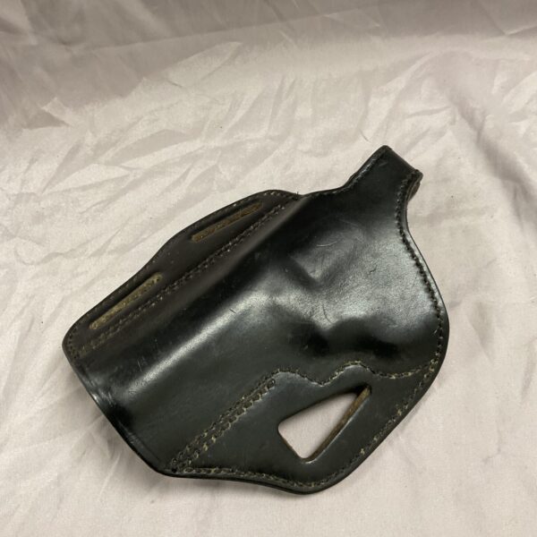 Vintage left-handed leather K frame pistol holster, showing wear.