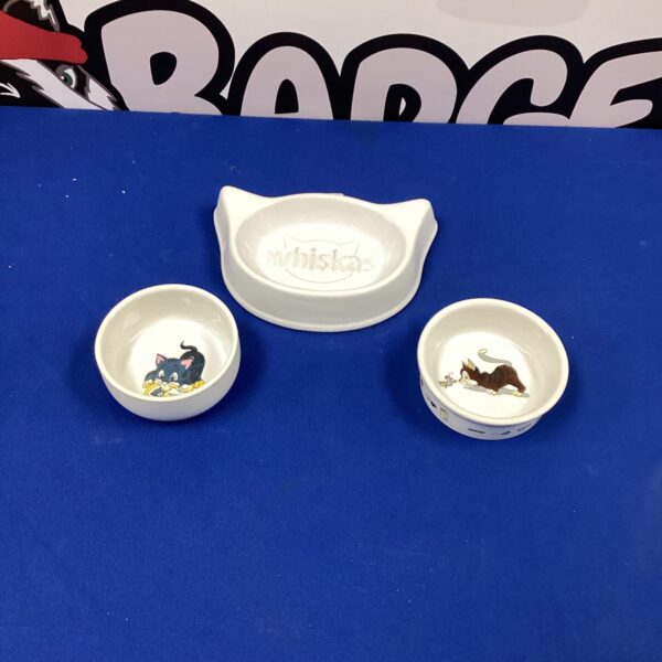 Vintage ceramic cat food dishes, Trixie and Whiskas brands, collectible pet bowls.