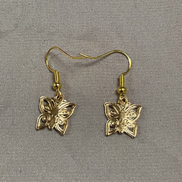 Close-up of vintage silver gilt butterfly earrings with detailed wings.