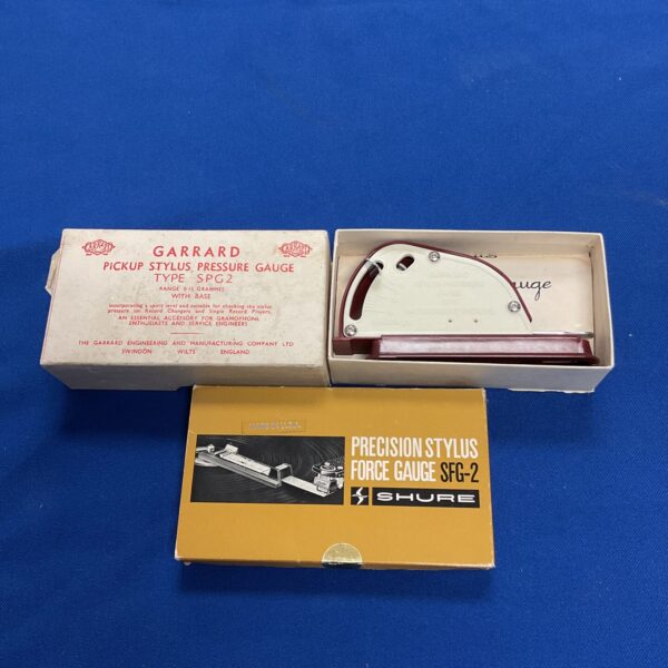 Vintage Shure and Garrard stylus force gauges for vinyl record players.