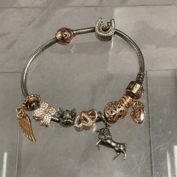 Pandora silver charm bracelet with floral and animal charms.
