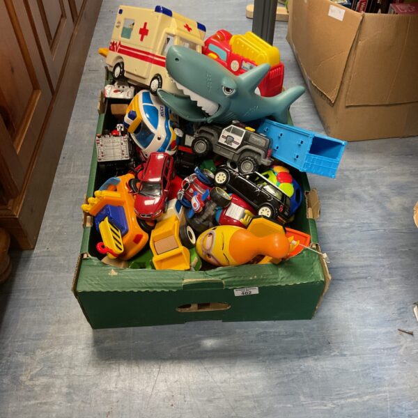 Crate filled with a mixed lot of toy vehicles and diecast cars.