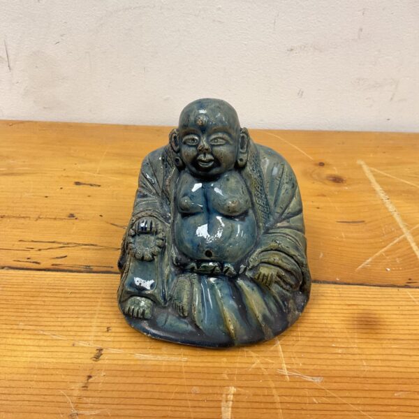 Small ceramic Buddha statue with teal glaze.