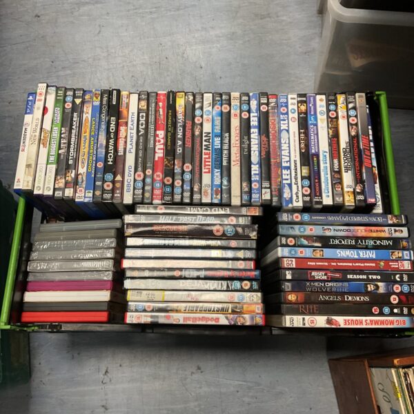 Crate filled with sealed and unsealed DVDs and video games.