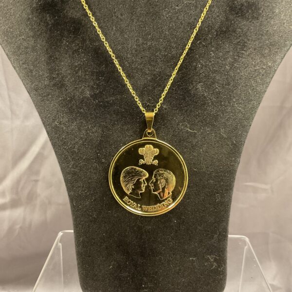 Vintage Charles and Diana pendant on a necklace.