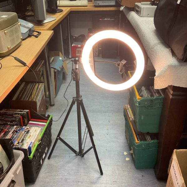 Portable LED selfie ring light on tripod stand for photography.