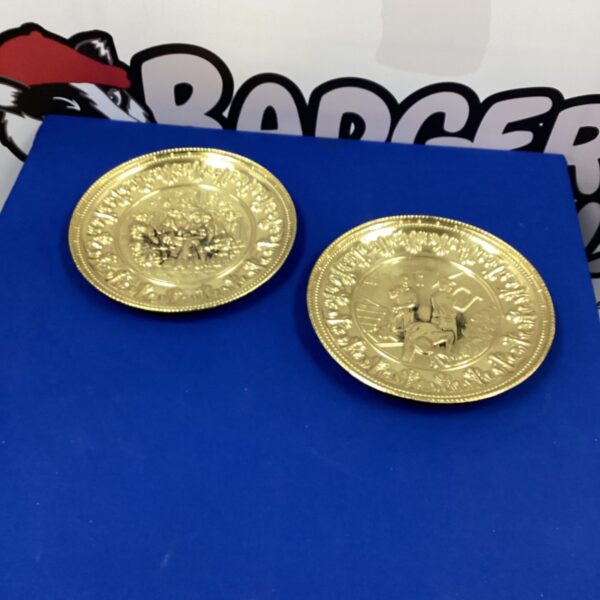 Two vintage copper decorative wall plaques with embossed designs.