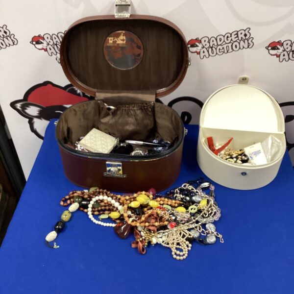 Vintage jewellery boxes filled with costume jewellery and beaded necklaces.
