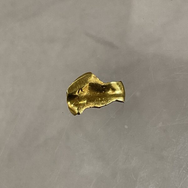 Antique gold tooth cap, a vintage dental gold artifact.