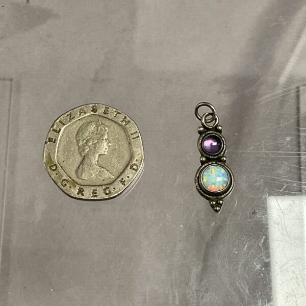 Vintage silver pendant with opal and amethyst gemstones.