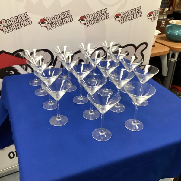 Set of eighteen large cocktail glasses for serving drinks.