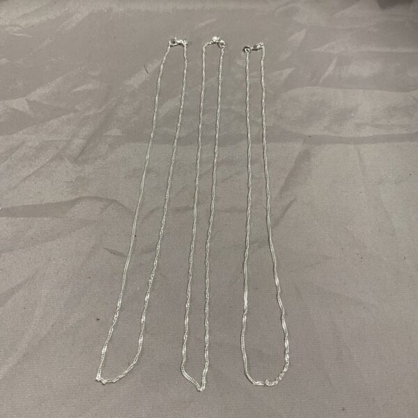 Three delicate silver chain necklaces, 18 inches long.