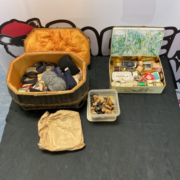 Vintage sewing basket filled with colourful sewing accessories and thread.