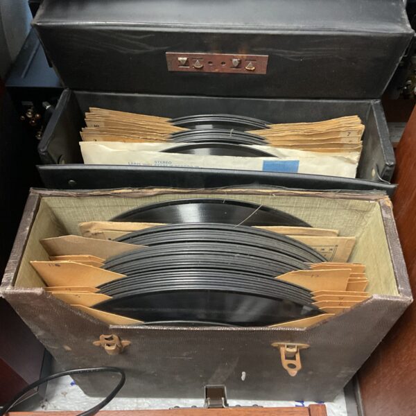 Vintage gramophone records stored in protective cases.