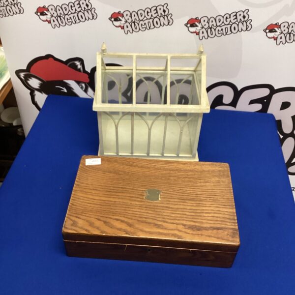Vintage miniature glasshouse with wooden frame and glass panels.