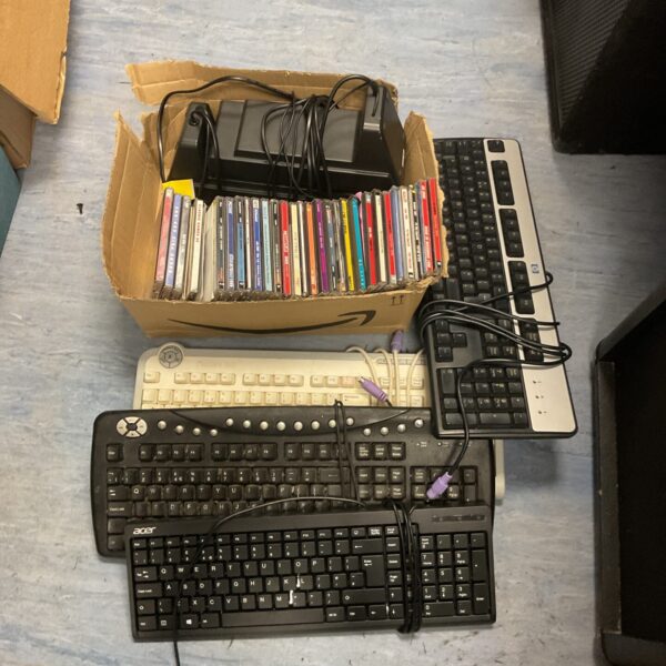 Mixed lot of vintage computer keyboards and software collection.