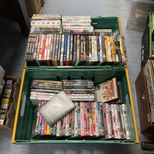 Mixed lot of DVDs and CDs in plastic crates.