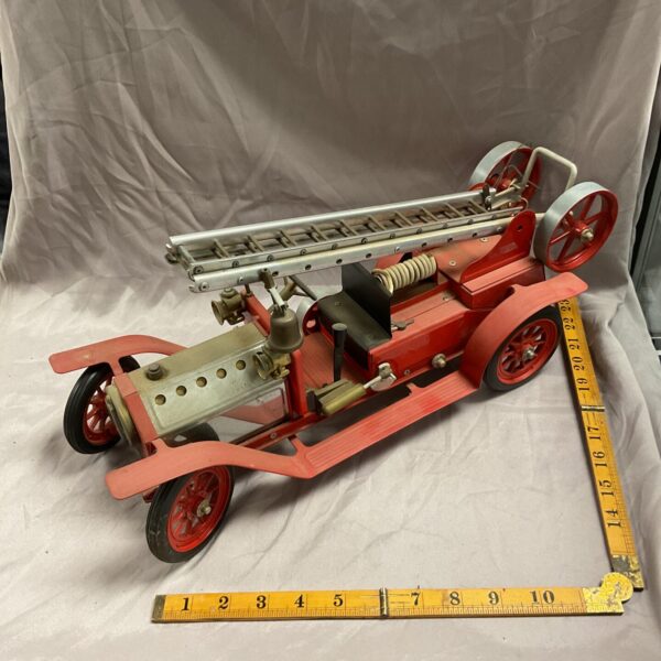 Side view of a vintage Mamod steam fire engine.