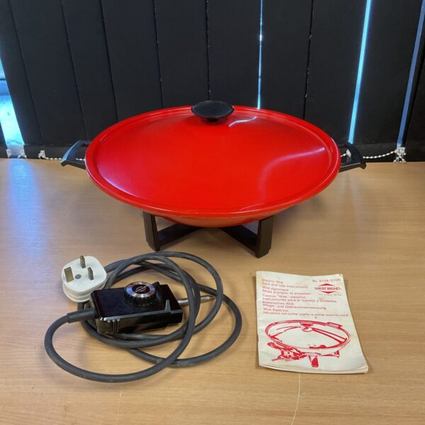 Vintage West Bend electric wok with black handle.