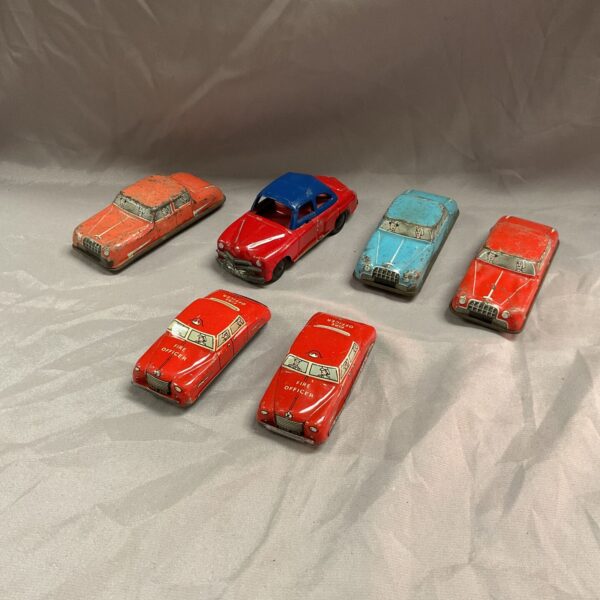 Lot of six vintage tin plate cars, collectible retro toys.
