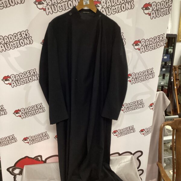 Front view of a black cassock, a traditional religious garment.