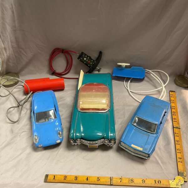 Lot of three vintage remote control cars with remotes.