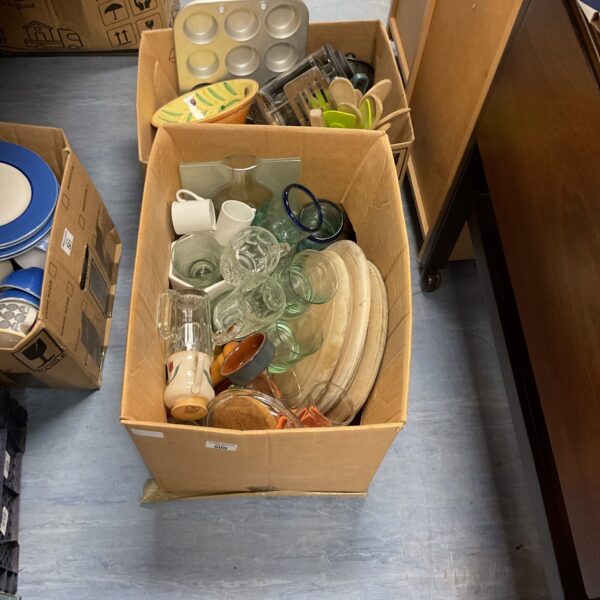 Mixed kitchenware lot with plates, bowls, and pottery items.