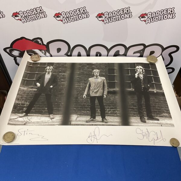 Vintage The Police signed poster featuring Sting and the band.